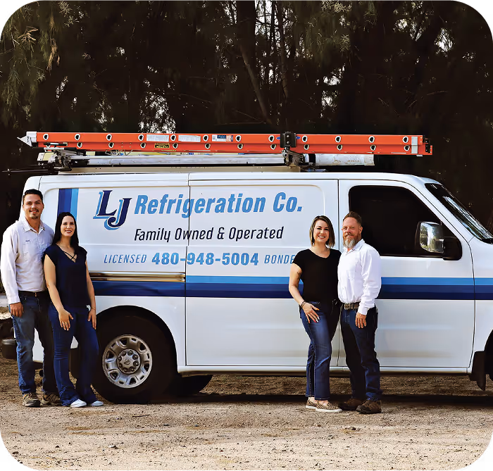 Members of the LJ Refrigeration family standing beside the company's lettered service van